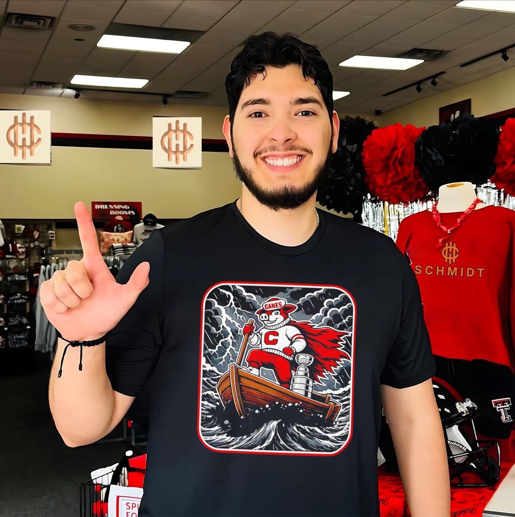 Carolina Hurricanes mascot on boat with Stanley Cup 2026 Champions shirt