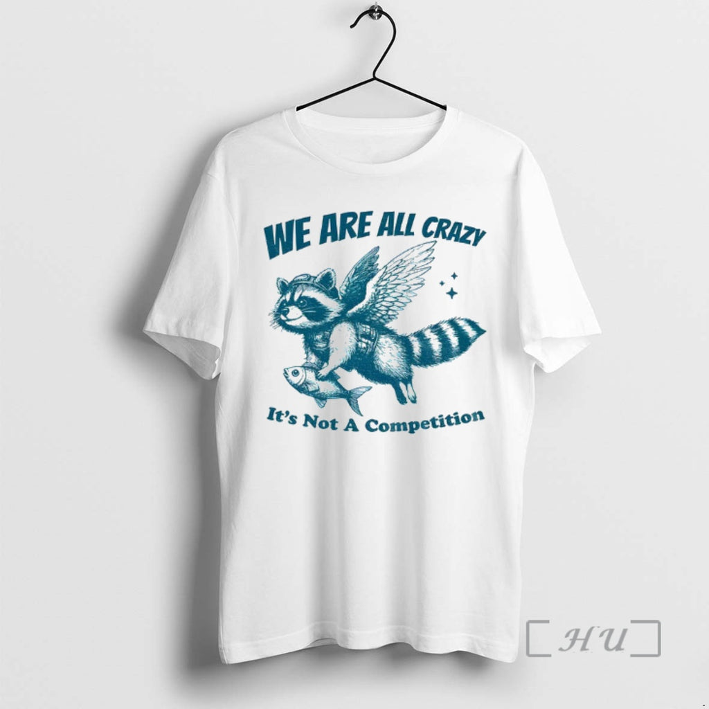 Trending Raccoon Holding Fish Fly We Are All Crazy Its Not A Competition Premium Shirt Hoodie Sweatshirt | PurePodTees.com